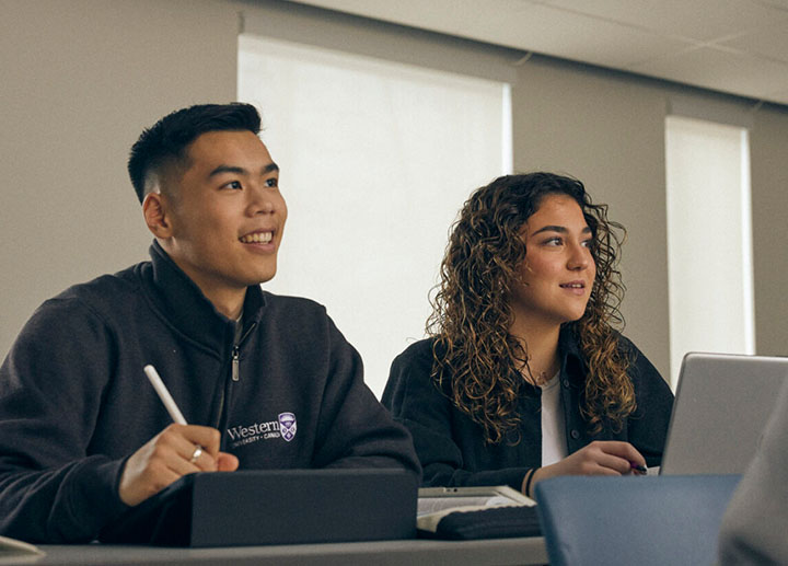 Two students paying attention in class