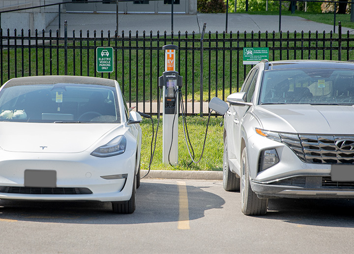 Two cars charging in parking lot